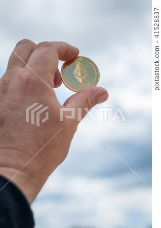 Ethereum coin in hand 41528837