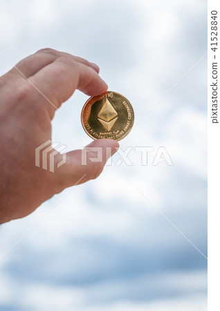 Ethereum coin in hand 41528840