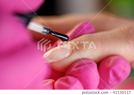 beautician applying Polish nails 41530117