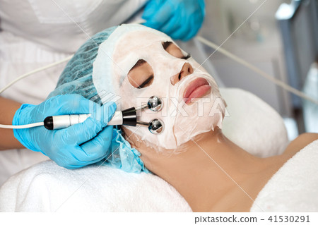 beautician applies face mask on woman 41530291