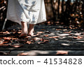 woman in white dress walking barefoot on wooden 41534828
