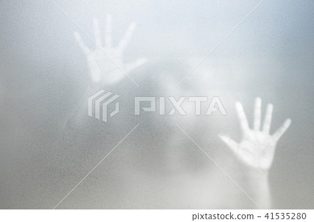 Shadow of woman on the white frosted glass 41535280