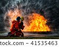 fireman using water fighting with fire flame 41535463