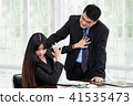 Man molesting women employee in the office. 41535473
