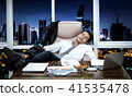 businessman sleeping on couch  in office 41535478