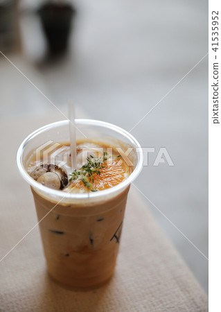 Iced Coffee latte with orange mix in close up Iced Coffee latte with orange mix in close up 41535952