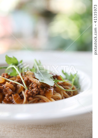 spaghetti Bolognese with minced beef and tomato sauce garnished with parmesan cheese and basil , Italian food spaghetti Bolognese with minced beef and tomato sauce garnished with parmesan cheese and basil , Italian food 41535973