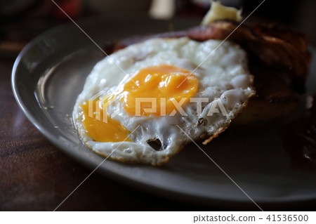 Breakfast french toast with bacon egg and cheese with jam on wood table background Breakfast french toast with bacon egg and cheese with jam on wood table background 41536500