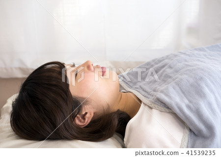 A lady sleeping on his back 41539235