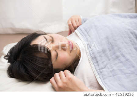 A lady sleeping on his back 41539236