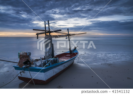 A fishing boat on beach in dawn A fishing boat on beach in dawn 41541132