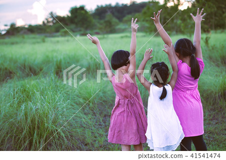 Asian children raise hands and playing together Asian children raise hands and playing together 41541474