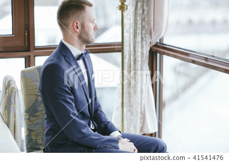elegant groom in a hotel room elegant groom in a hotel room 41541476
