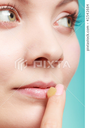 woman applying balsam for lips woman applying balsam for lips 41541684