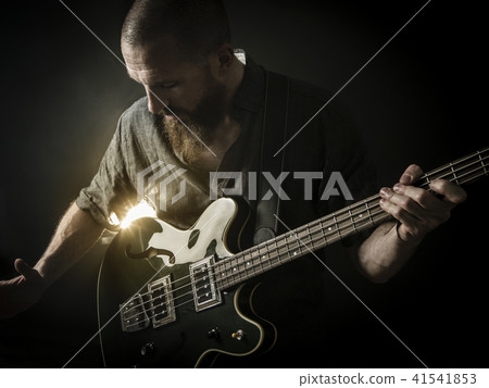 Bearded man playing bass guitar Bearded man playing bass guitar 41541853