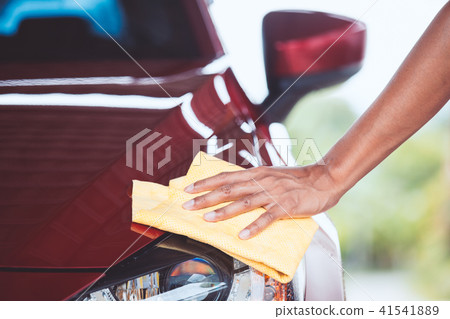 Man washing and cleaning car with microfiber cloth Man washing and cleaning car with microfiber cloth 41541889