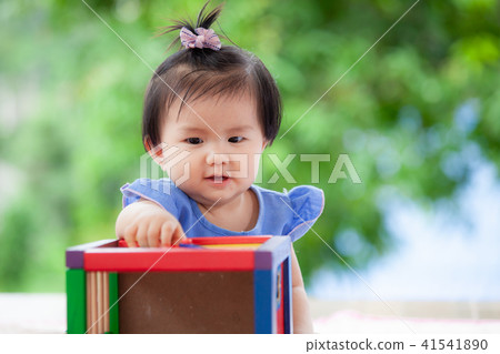 Cute asian baby girl playing with her toy Cute asian baby girl playing with her toy 41541890