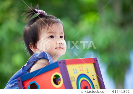 Cute asian baby girl playing with her toy Cute asian baby girl playing with her toy 41541891