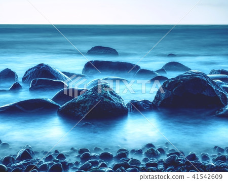 Peaceful morning sea with stones in peaceful level 41542609