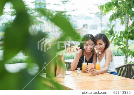 Female friends watching funny videos 41543553