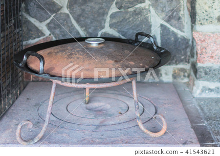 Cast iron wok on a wood stove Cast iron wok on a wood stove 41543621