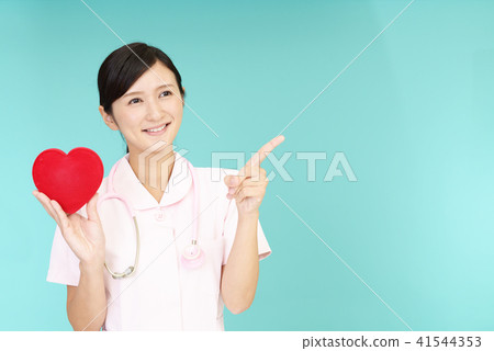 A smiling nurse with a heart mark A smiling nurse with a heart mark 41544353
