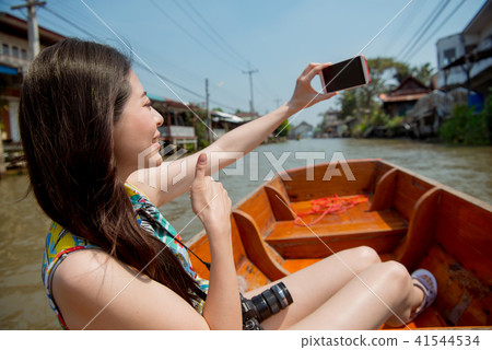 Woman making selfie on floating market background Woman making selfie on floating market background 41544534