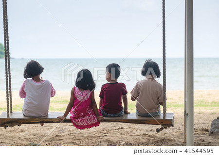 Children Playing Giant Swing Together by the Sea. Children Playing Giant Swing Together by the Sea. 41544595