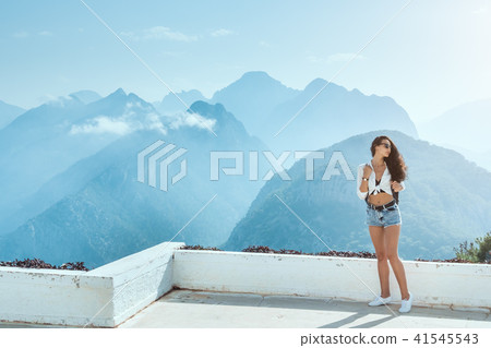 Beautiful young tourist girl with backpack at mountains 41545543