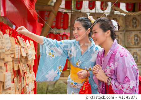 woman hanging their wishes 41545873