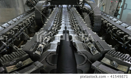 Manufacture of plastic water pipes. Manufacturing of tubes to the factory. The process of making Manufacture of plastic water pipes. Manufacturing of tubes to the factory. The process of making 41549871