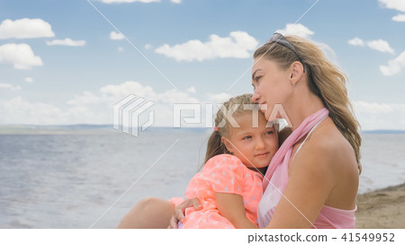Little cute girl and young mother at beach. Little cute girl and young mother at beach. 41549952