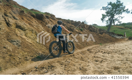 Fat bike also called fatbike or fat-tire bike in summer driving on the road. Fat bike also called fatbike or fat-tire bike in summer driving on the road. 41550394