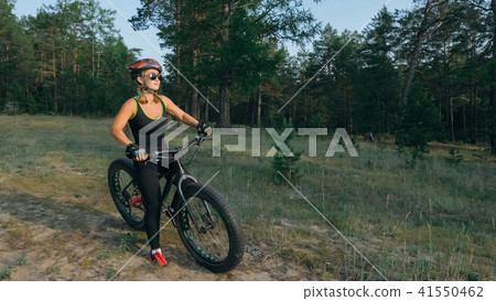 Fat bike also called fatbike or fat-tire bike in summer riding in the forest. 41550462