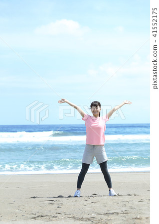 A woman stretching on the coast 41552175