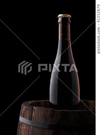 Cold bottle of craft beer on old wooden barrel 41552679