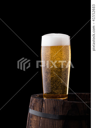 Cold glass of craft beer on old wooden barrel 41552683