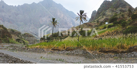 Panorama of dried canyon between fertile green valley and rugged cliffs. Santo Antao, Cabo Verde Panorama of dried canyon between fertile green valley and rugged cliffs. Santo Antao, Cabo Verde 41553753