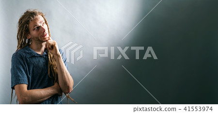 Young man in a thoughtful pose 41553974