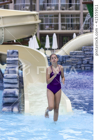 Beautiful young girl in a purple swimsuit Beautiful young girl in a purple swimsuit 41555911
