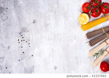 Ingredients for preparing pasta and sauce isolated on stone background. Ingredients for preparing pasta and sauce isolated on stone background. 41557083