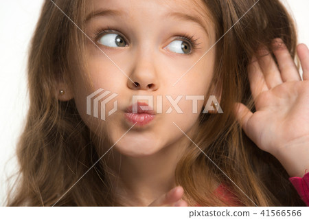 The young teen girl whispering a secret behind her hand over white background 41566566