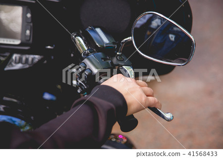 Close up Hand a man hold manual brake and stop running of motor cycle safety concept on the road 41568433