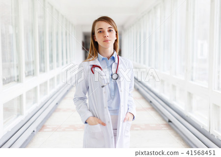 Portrait of beautiful young female doctor with stethoscope in clinic Portrait of beautiful young female doctor with stethoscope in clinic 41568451