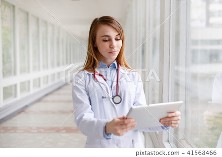 Portrait of modern female doctor with tablet Portrait of modern female doctor with tablet 41568466