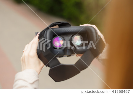 Modern technology vr headset in woman hands 41568467