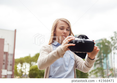 Modern technology vr headset in woman hands Modern technology vr headset in woman hands 41568471