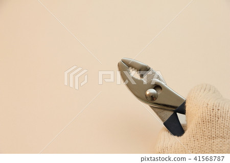 Pliers held with glove hands 41568787