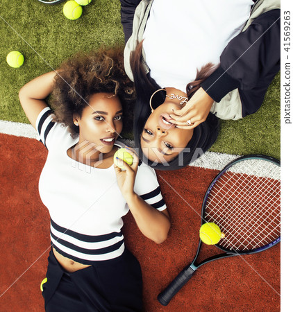 young pretty girlfriends hanging on tennis court, fashion stylis 41569263