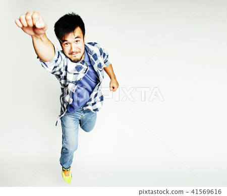 young pretty asian man jumping cheerful against white background 41569616